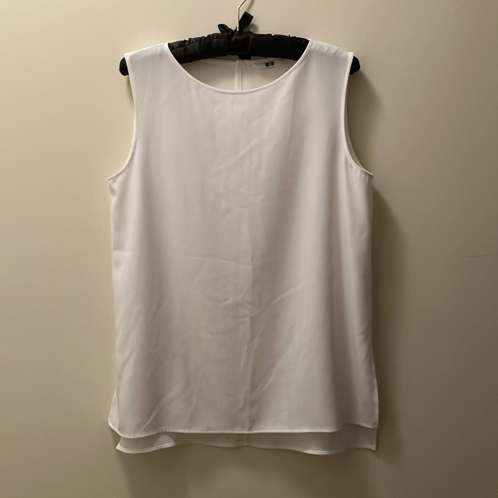 Long cream colored blouse with side slits.